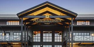 Exterior view of Mountain Timber Market’s industrial brick and metal community building in Kalama.
